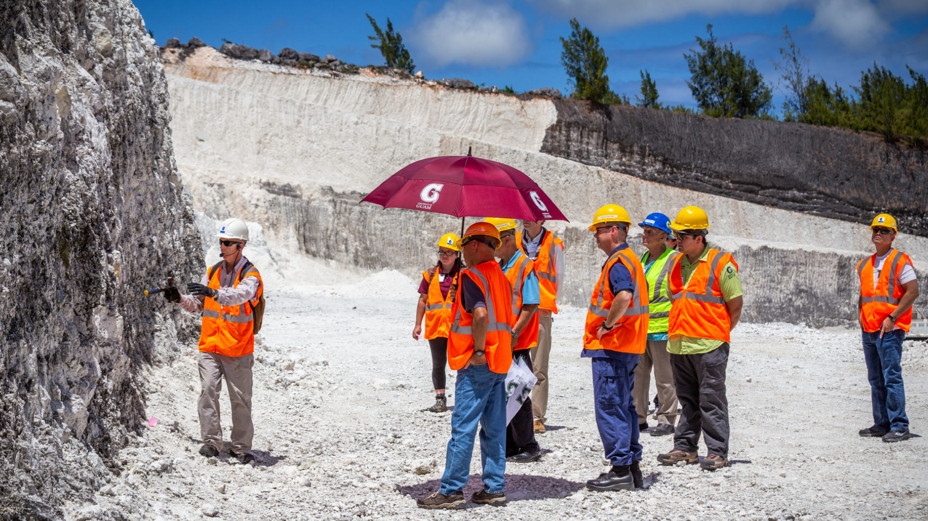 NGLA Executive Tour. Dr. Jenson (WERI Director) discussing features of Barrigada Limestone at Department of Public Works Quarry, Dededo. The GHS outreach includes the NGLA Tour for executive leader representatives of the legislature, heads of private sector, and University of Guam. (photo: Eugene Herrero, UOG)